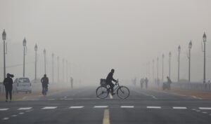 People cycle, run and walk through thick smog in Delhi. The city recorded zero clean-air days in 2025, making it one of the most persistently polluted capitals in the world. (Photo: Reuters)