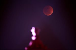 A red Moon rises over India's Ministry of Finance building during a lunar eclipse in New Delhi, India. (Photo: Reuters)