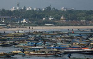 Fishermen tie their fishing boats off the coast of Visakhapatnam, India. (Photo: Reuters)
