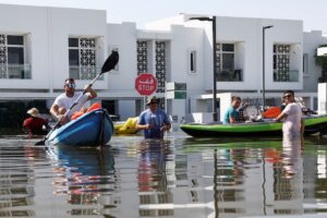 Residents move their belongings on a kayak following heavy rainfall, in Dubai. (Photo: Reuters
