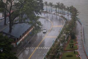 A car moves on a road along the coast while rain pours in Vietnam. (Photo: Reuters)
