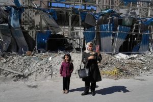 A woman stands amid rubble after the US-Israeli strikes in Tehran (Reuters)