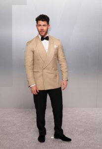 Nick Jonas kept it simple in a beige double breasted tuxedo! (REUTERS)