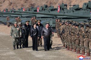 In this photo provided by the North Korean government, its leader Kim Jong Un, center, and his daughter, reportedly named Kim Ju Ae, visit a military training base in North Korea, Thursday, March 19, 2026.