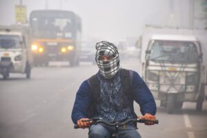 A cyclist commutes during a cold and foggy winter morning. (Photo: PTI)