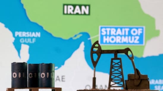 3D-printed oil barrels, an oil pump jack and a map showing the Strait of Hormuz and Iran appear in this illustration.