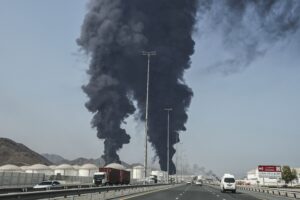 Smoke rises from the direction of an energy installation in the Gulf emirate of Fujairah on March 14, 2026. Smoke could be seen rising from the direction of a major UAE energy installation on March 14, in what appeared to be the latest strike targeting the Gulf's petroleum facilities hours after the US struck Iran's Kharg Island. (Photo by AFP) /