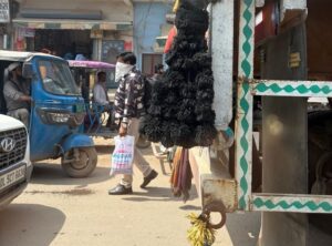 A man walks on a dusty road with his face covered. (Photo: ITG/Aryan Rai)