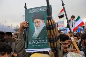 Houthi supporters brandish rifles and hold a portrait of Iran's slain supreme leader Ayatollah Ali Khamenei during a rally in solidarity with Iran and Lebanon, in the Yemeni capital Sanaa on March 6 (AFP)