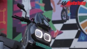 The front features striking twin LED headlamps that give the scooter a distinctive, almost bug-eyed appearance.