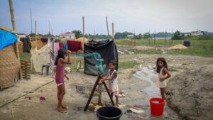 Children use a groundwater pump inside a makeshift shelter camp in Goalpara district in the northeastern state of Assam. (Photo: Reuters)