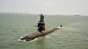 A Kalvari-class Indian Navy submarine sails through the waters off Mumbai with the city skyline in the background. (Photo: PTI)