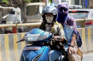 Commuters shielding themselves from the early March sun in northwest India. (Photo: PTI)