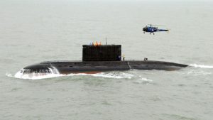 A Sindhughosh-class Indian Navy submarine on the surface during exercises, with a Navy helicopter visible overhead. (Photo: Special arrangement/Commodore Anil Jai Singh (Retd))