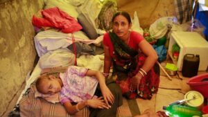 Raj Kishore Kumar, a 12-year-old cancer patient, rests with his mother inside his pavement dwelling outside the Tata Memorial Hospital in Mumbai. (Photo: Reuters)