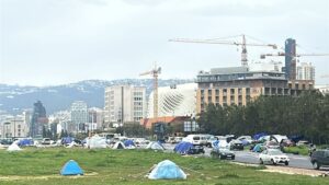 Makeshift tents dot the landscape, reflecting the scale of displacement as Beirut absorbs wave after wave of families forced from their homes.
