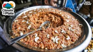 A worker carries gaajar ka halwa, a sweet dish made from carrots and milk. (Photo: Reuters)