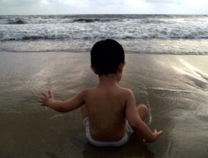 A two-year-old boy cools himself off at a beach in Mumbai. (Photo: Reuters)