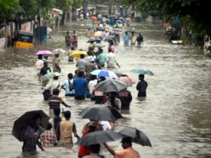 People wade through a flooded road after heavy rains in Chennai, Tamil Nadu. (Photo: Reuters)