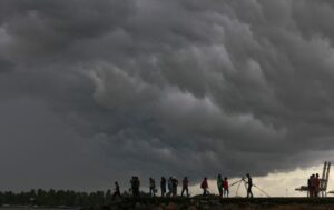 People stand on a seaside promenade as pre-monsoon clouds gather in Kochi, Kerala. (Photo: Reuters)