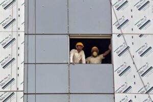 Labourers look out from a window of a data centre building under construction in Gujarat. (Photo: Reuters)