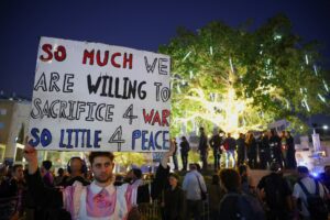A demonstrator holds up a sign during an anti-war protest calling for an end to the U.S.-Israel conflict with Iran, in Tel Aviv, Israel, April 4, 2026. (REUTERS)