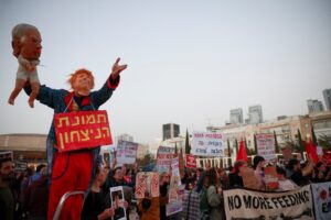 A demonstrator wears a mask depicting U.S. President Donald Trump while holding a puppet of a baby with a mask depicting Israeli Prime Minister Benjamin Netanyahu during an anti-war protest calling for an end to the U.S.-Israel conflict with Iran, in Tel Aviv, Israel, April 4, 2026. (REUTERS)