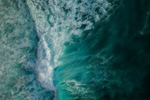 An aerial view capturing the vibrant movement of crashing ocean waves. (Representational Photo: Pexels)