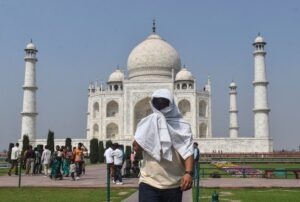 A man covers himself from the heat at the Taj Mahal. (Photo: PTI)
