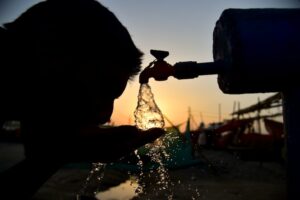 A man drinking water from a tap on a hot day in Uttar Pradesh. (Photo: PTI)
