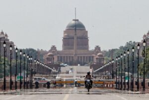 A biker cruises along the Kartavya Path as mirage appears on a hot summer day, in New Delhi. (Photo: PTI)