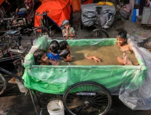 Children cool off in an improvised pool in Kolkata, West Bengal. (Photo: PTI)