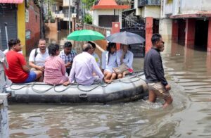 Rescue personnel evacuate residents by boat from a waterlogged area, in Guwahati, Assam. (Photo: PTI)