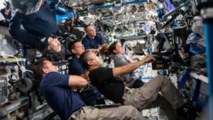 Expedition 68 crew members gather in the International Space Station’s Destiny laboratory module to participate in an evening conference with station mission controllers (Photo: Nasa)