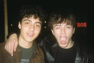 A photorealistic snapshot portrait of two friends outside a venue at night generated by ChatGPT Images 2.0