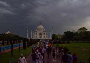 People gather at the Taj Mahal on a cloudy and rainy day. (Photo: PTI)
